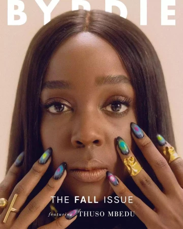 Close-up portrait of Thuso Mbedu with long dark hair, featuring artistic painted nails and gold rings by Elizabeth Weinberg.