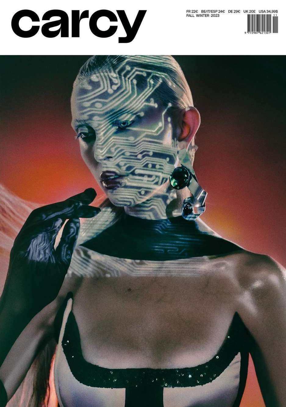 Magazine cover featuring a woman with circuit board design on her face, adorned with statement earring. The image has a futuristic, editorial feel.