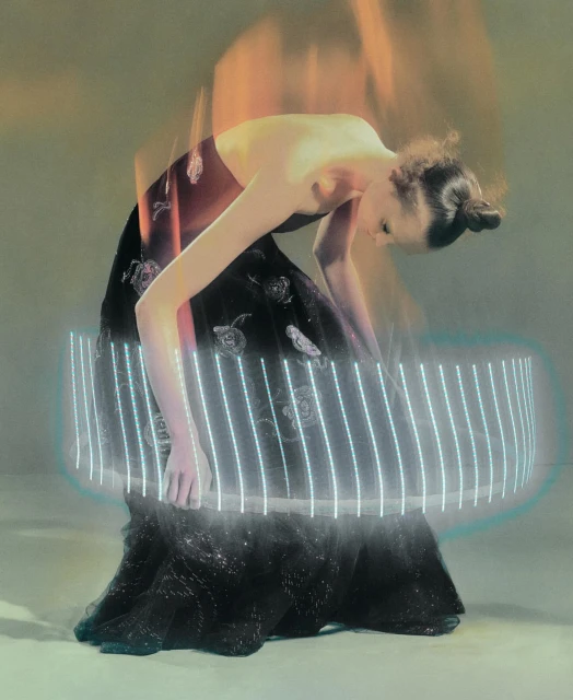 Woman in an elaborate gown interacts with a glowing ring in a surreal indoor setting, blending fashion and technology with unique visual effects.
