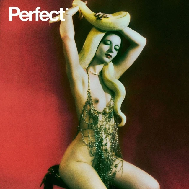 A nude woman adorned with jewelry and a snake poses seductively against a red backdrop, showcasing fashion and beauty.