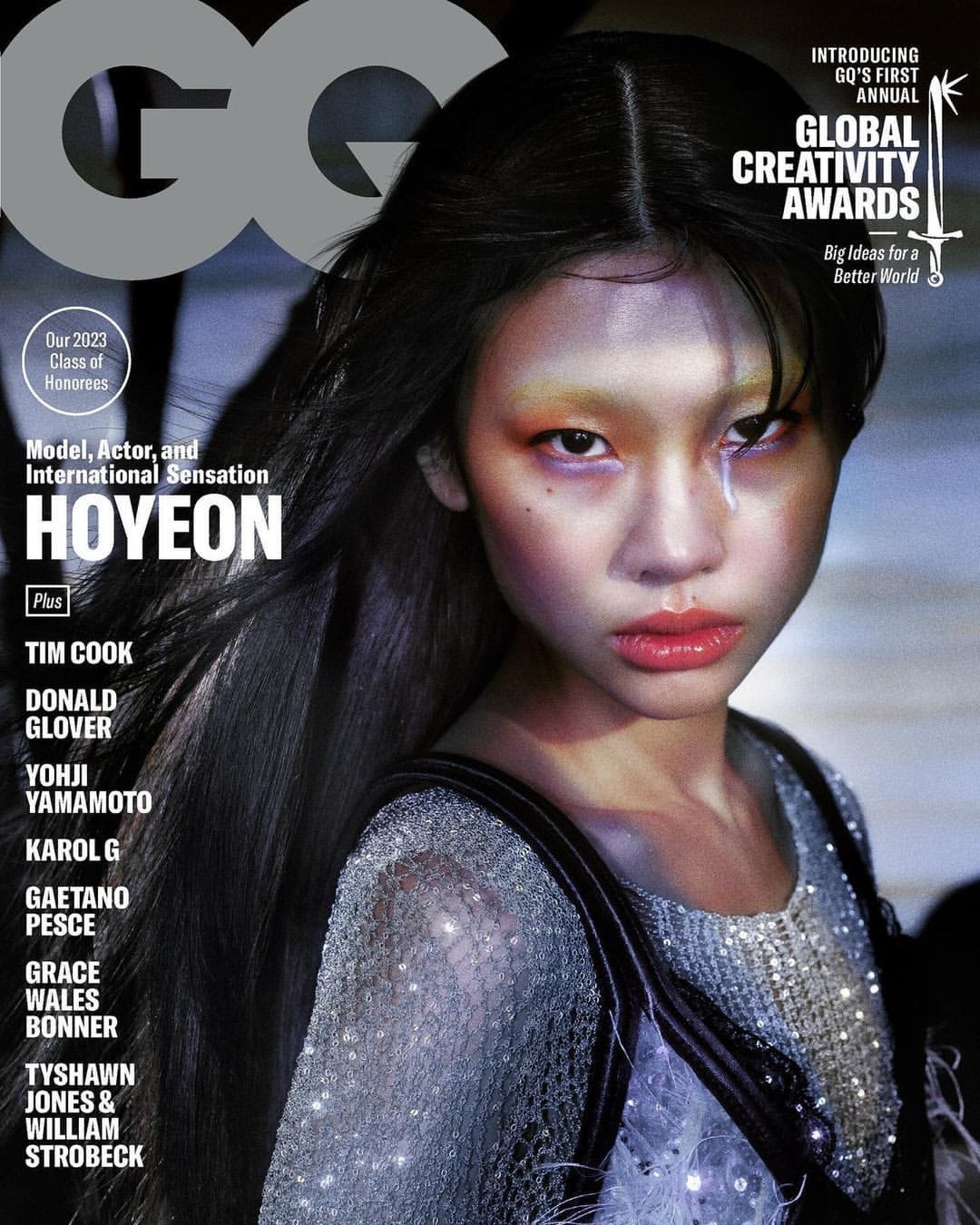 GQ magazine cover featuring model Hoyeon with dark hair and eye-catching makeup, showcasing a close-up shot with vibrant colors and bold typography.
