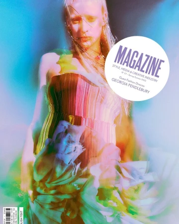 Model in a pleated colourful dress with overlaid magenta, blue, and green lighting by photographer Elizaveta Porodina.