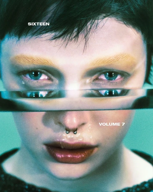 Close-up portrait of a person with striking blue eyes and a nose ring, reflected in a rectangular prism, against a teal background.