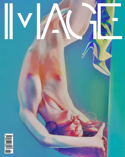 Upside-down studio portrait of a nude adult female with shiny high-heeled boots against a blue and green gradient backdrop.