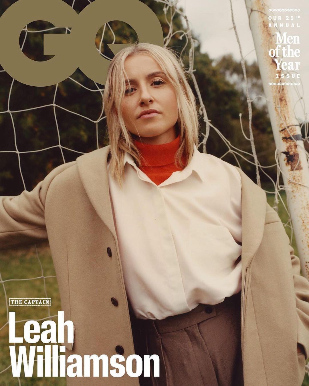 GQ magazine cover featuring Leah Williamson in a beige coat leaning against a soccer goalpost against an outdoor backdrop.