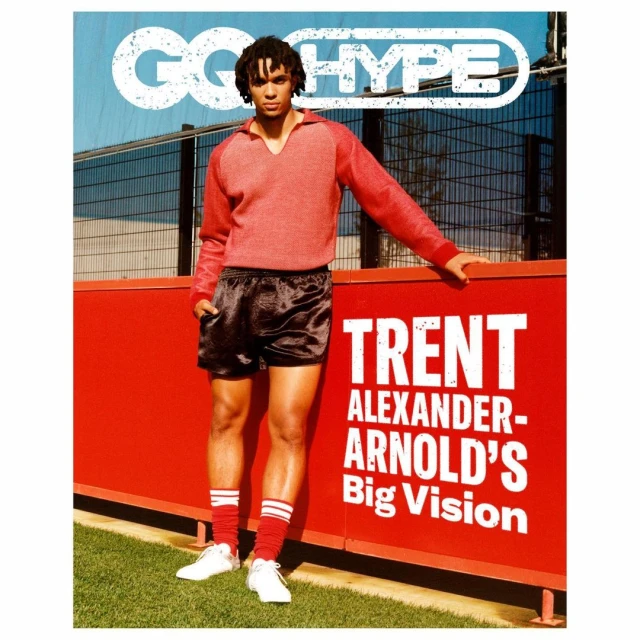Full shot of Trent Alexander-Arnold on a magazine cover, wearing a red sweater and black shorts, with the headline "GO HYPE" above him.