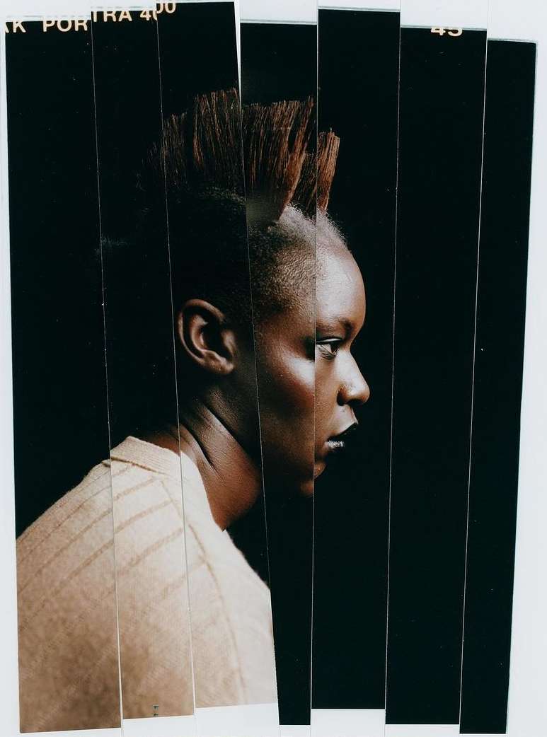 Portrait of a young African-American woman with a mohawk, presented in a fragmented, artistic style with black and white accents, studio lighting.