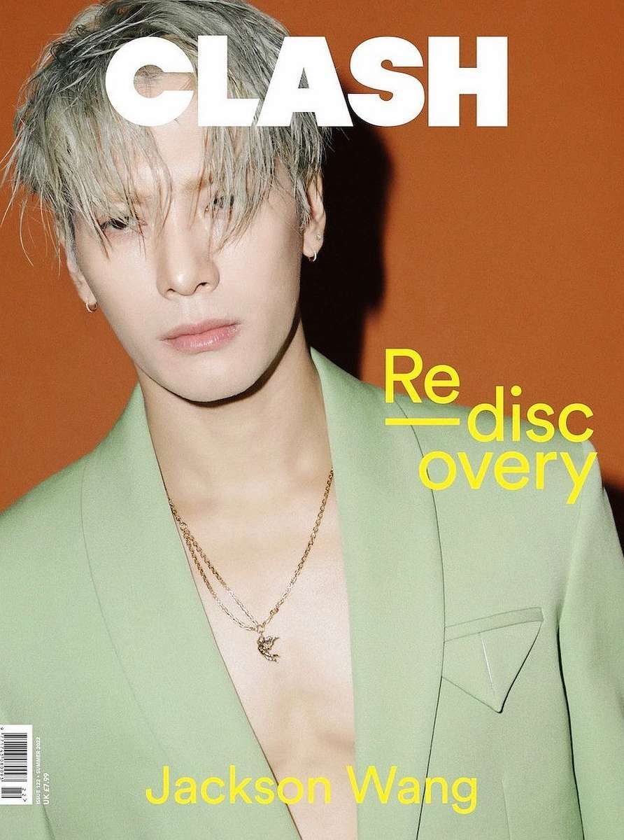 Magazine cover featuring Jackson Wang in a light green suit against an orange background, showcasing a fashion and celebrity aesthetic.