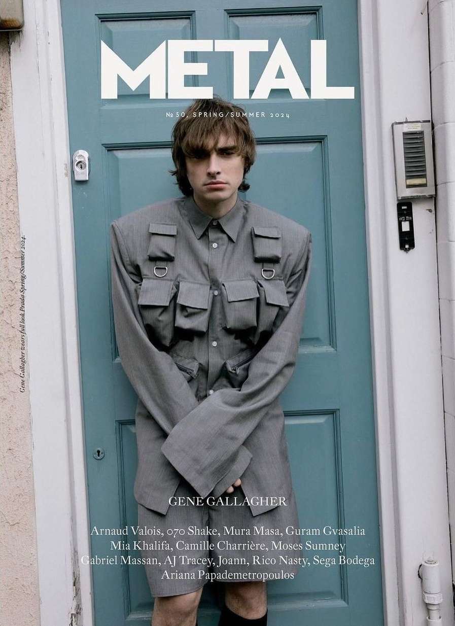 Metal magazine cover featuring Gene Gallagher in a grey utility outfit against a blue door. Spring/Summer 2024 issue.