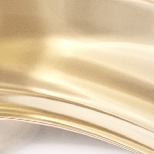 Close-up of shimmering gold fabric with soft, rippled texture and elegant folds, creating a luxurious and smooth aesthetic.