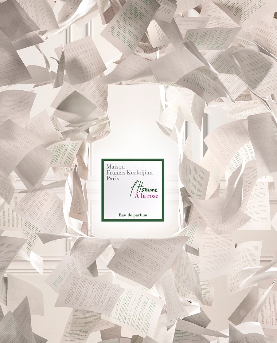 Fragrance bottle by Maison Francis Kurkdjian Paris, L'Homme A La Rose edition, surrounded by floating white paper, bright studio lighting.