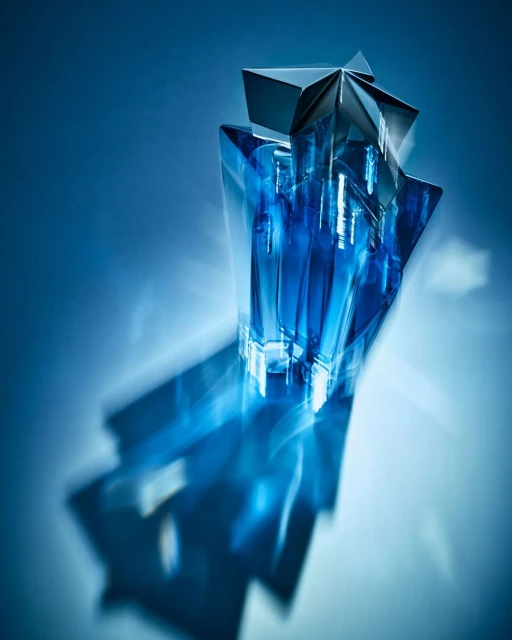 Star-shaped blue glass perfume bottle on a glossy surface with a matching blue background and long shadow, product photography.