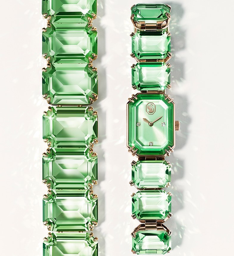Elegant fashion wristwatch featuring green crystals, gold accents, and precise timekeeping against a clean, bright backdrop.