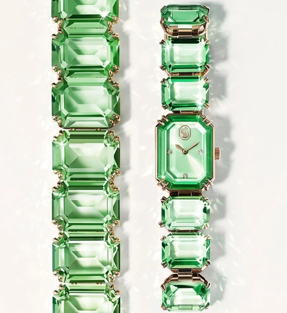 Elegant fashion wristwatch featuring green crystals, gold accents, and precise timekeeping against a clean, bright backdrop. 
