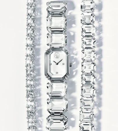 Sparkling Swarovski watch and bracelets on a white background, showcasing jewelry fashion and luxurious accessories.