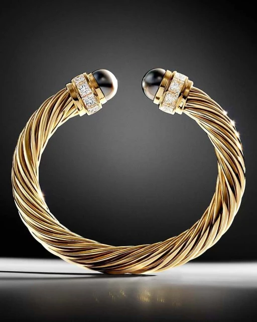 Gold-tone twisted bangle bracelet with black pearl accents and diamond embellishments, presented against a gradient gray background.