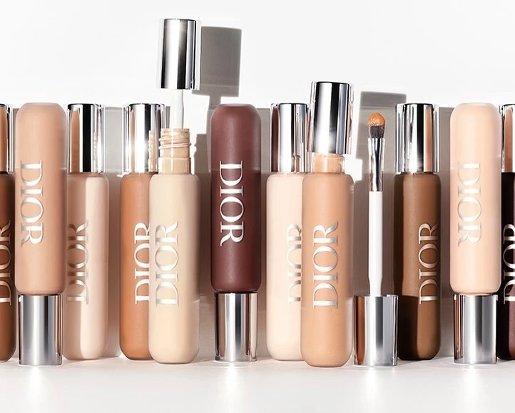 Dior foundation bottles in various shades, displayed in a row with silver caps and white lettering against a bright white background.
