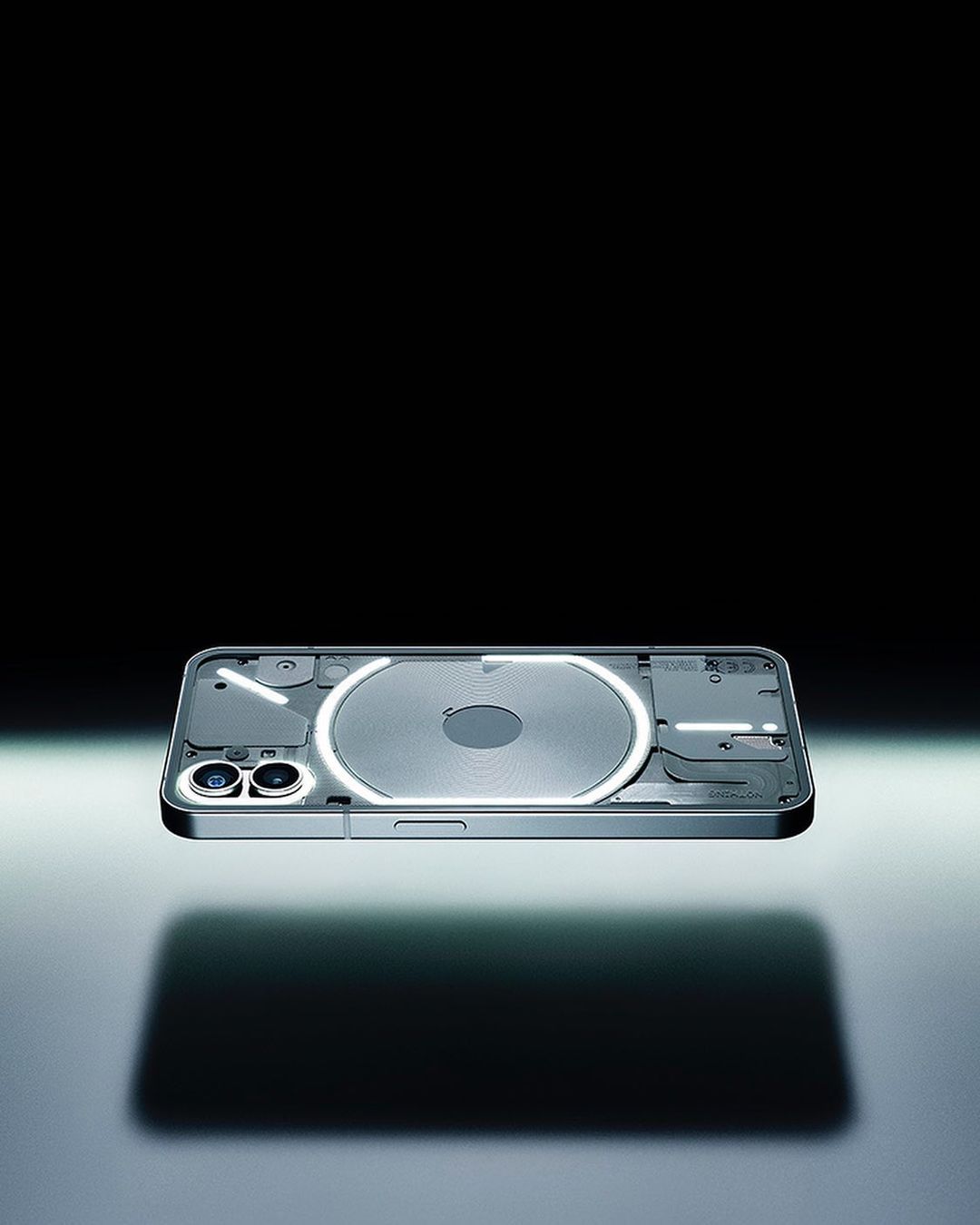Nothing Phone (2a) with glowing glyph interface floating against a dark background, casting a shadow, product shot.