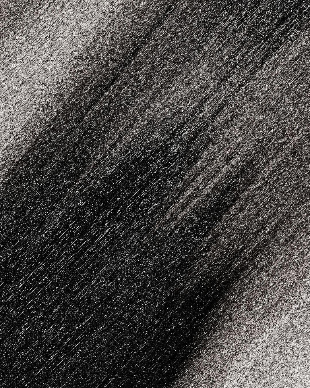 Abstract monochrome background with black and gray diagonal brush stroke texture pattern, creating a dynamic and artistic visual.