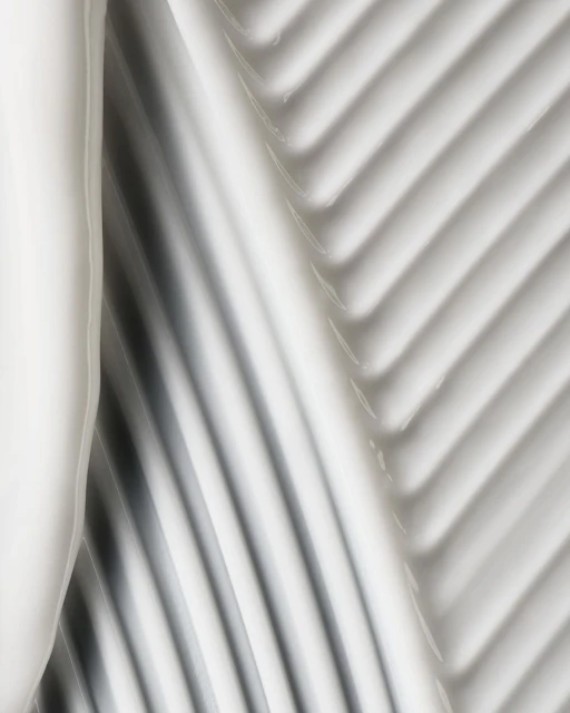 Abstract close-up of thick, glossy white cream with diagonal ridged texture, neutral lighting, ideal for beauty product marketing.