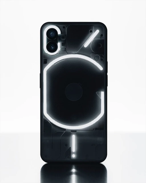 Black 'Nothing Phone' with illuminated glyph interface on a white surface. The phone features a unique transparent design and dual camera.
