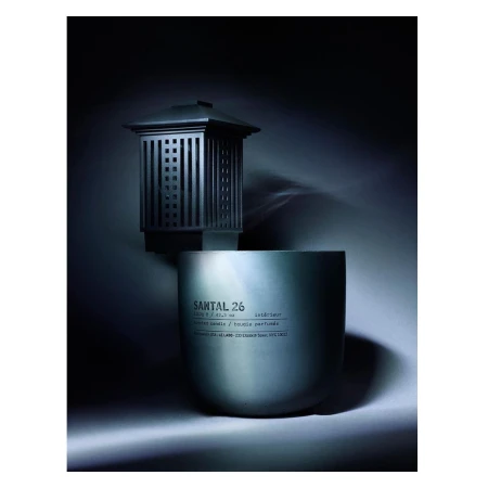 Santal 26 candle and diffuser set on a gradient gray background with moody lighting, showcasing a modern home fragrance product.