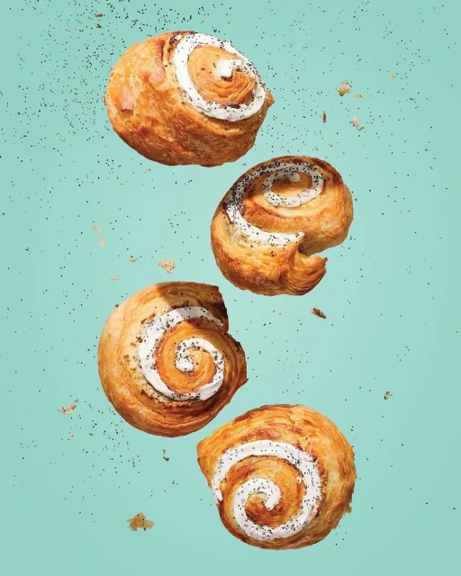 Eye-level, close-up shot of a visually striking, appetizing pastry arrangement, with a blue background, creating an appealing dessert image.