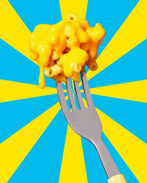 Overhead shot of a fork holding macaroni and cheese with yellow sauce against a burst background of blue and yellow stripes.