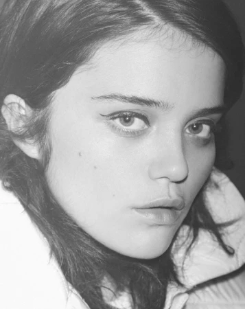 Monochrome close up portrait of a young woman with dark hair and eyeliner by photographer Pierre Toussaint