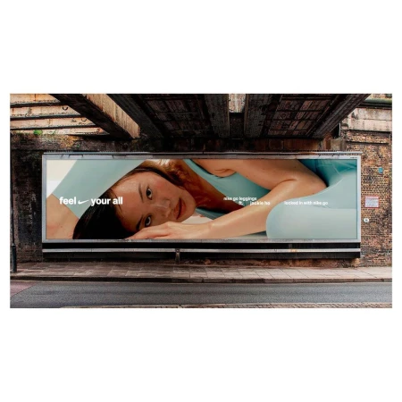 Nike ad on an urban billboard: woman in activewear, angled pose, close-up, natural light, promoting Nike Go leggings with Jackie H.