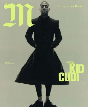 Magazine cover featuring Kid Cudi in a black coat and boots, standing against a light background with neon green text accents.