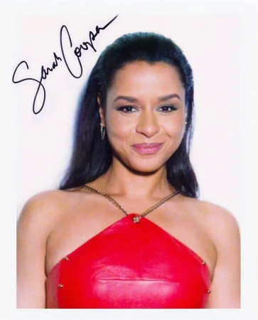 Portrait of Sarah Cooper in a red dress against a white background, featuring her signature prominently displayed on the image.