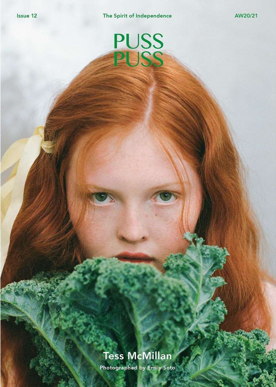 Magazine cover featuring a young woman with red hair holding kale, shot in eye-level portrait framing with a shallow depth of field.