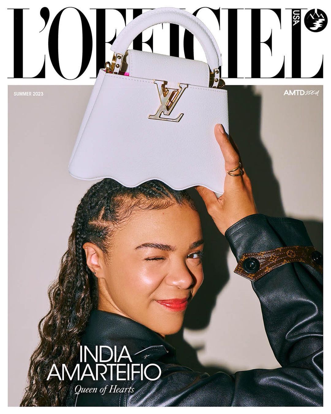 L'Officiel USA cover featuring India Amarteifio holding a white Louis Vuitton purse, with the magazine's masthead and text overlays.