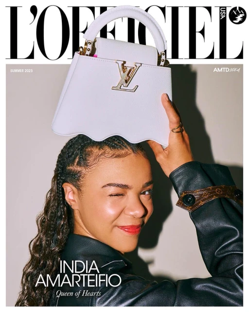 L'Officiel USA cover featuring India Amarteifio holding a white Louis Vuitton purse, with the magazine's masthead and text overlays.