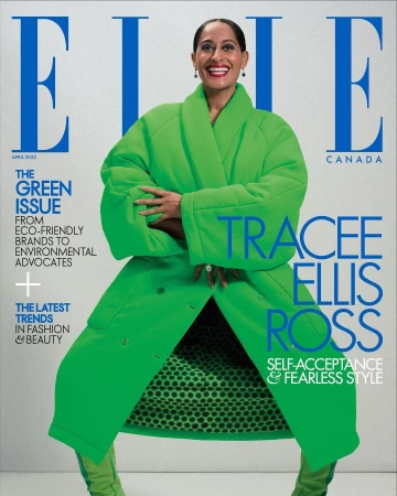 Tracee Ellis Ross on the cover of Elle Canada, April 2022, wearing a bright green coat and boots with a polka dot lining against a white background.