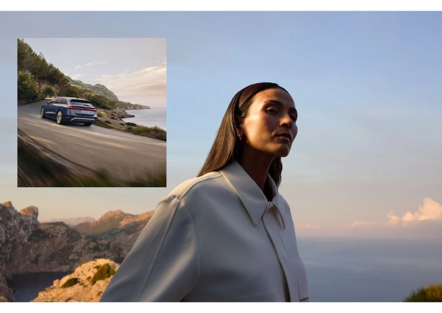 Woman in front of coastal view and luxury car driving on scenic road. Clear blue sky and mountains in background. Automotive beauty shot.