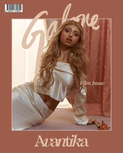 Magazine cover featuring a young woman in a white satin outfit, shot indoors with a rose, and a tan color palette.