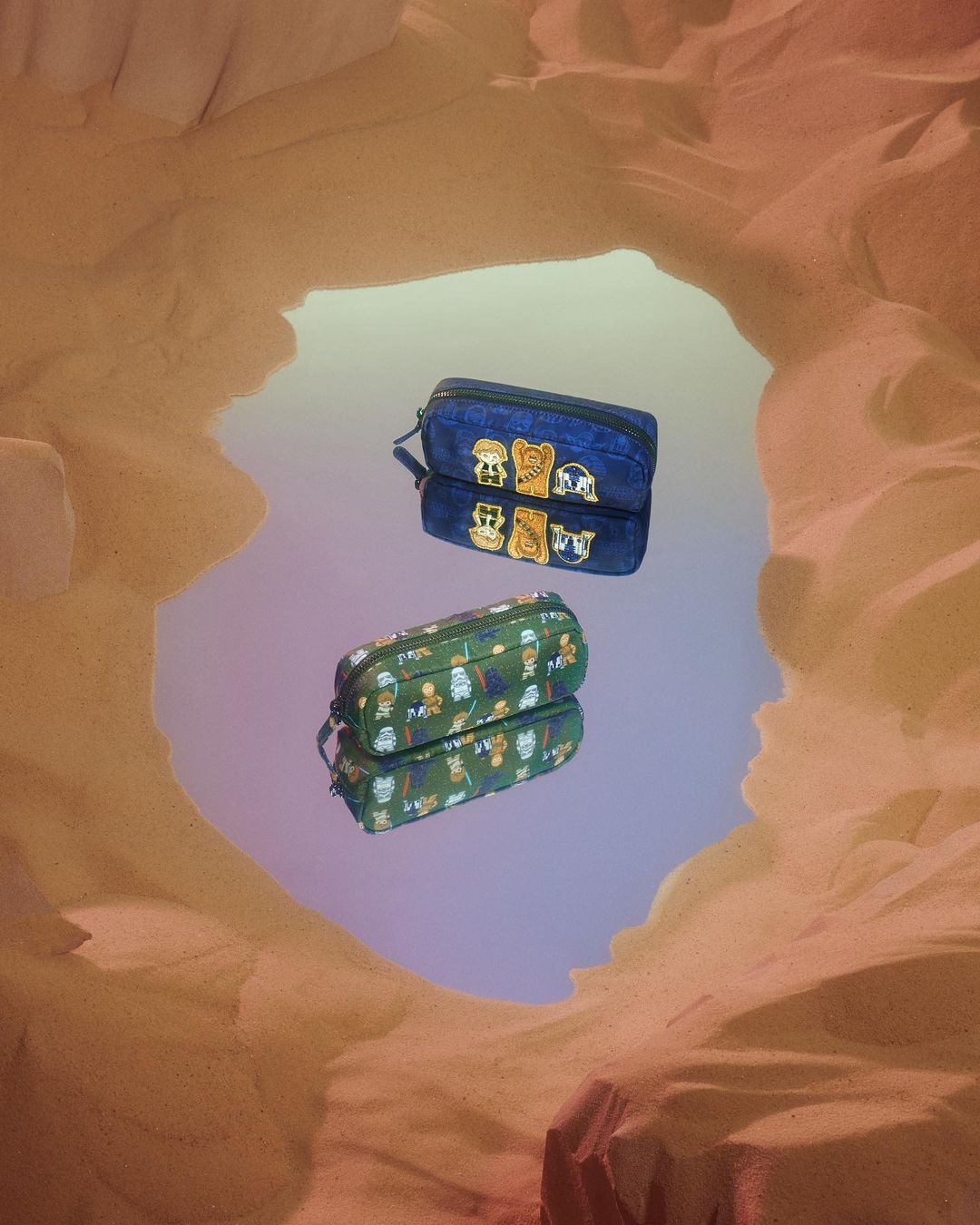 Two pencil cases reflected in a mirror, featuring character designs against a tan backdrop reminiscent of a desert landscape.