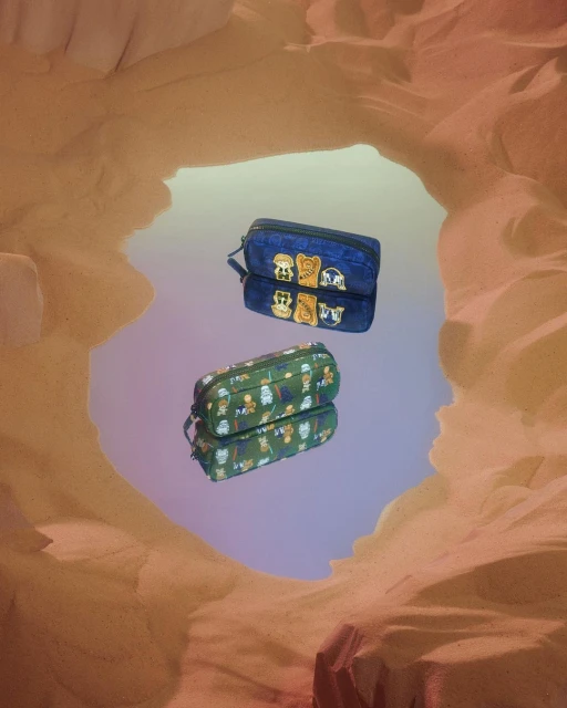 Two pencil cases reflected in a mirror, featuring character designs against a tan backdrop reminiscent of a desert landscape.