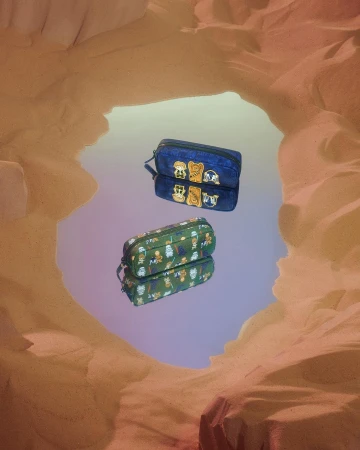 Two pencil cases reflected in a mirror, featuring character designs against a tan backdrop reminiscent of a desert landscape.