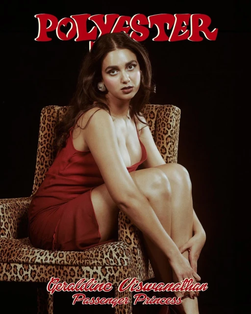 Woman in a red dress sits in a leopard-print chair against a black background. Image includes the words 'Polyester,' 'Geraldine Viswanathan,' and 'Passenger Princess'.