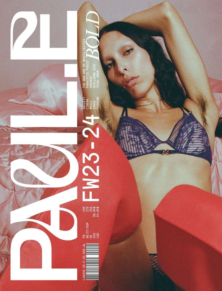 Magazine cover featuring a model in lingerie, with bold typography and fashion-related text, and a pink and red color scheme.
