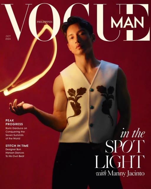 Vogue Philippines cover featuring Manny Jacinto in a sleeveless vest with floral accents, against a deep red backdrop and bright light trails.