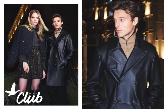 Fashion editorial shot featuring a blonde woman in a jacket and skirt, and a brunette man in a leather trench coat, posing indoors.