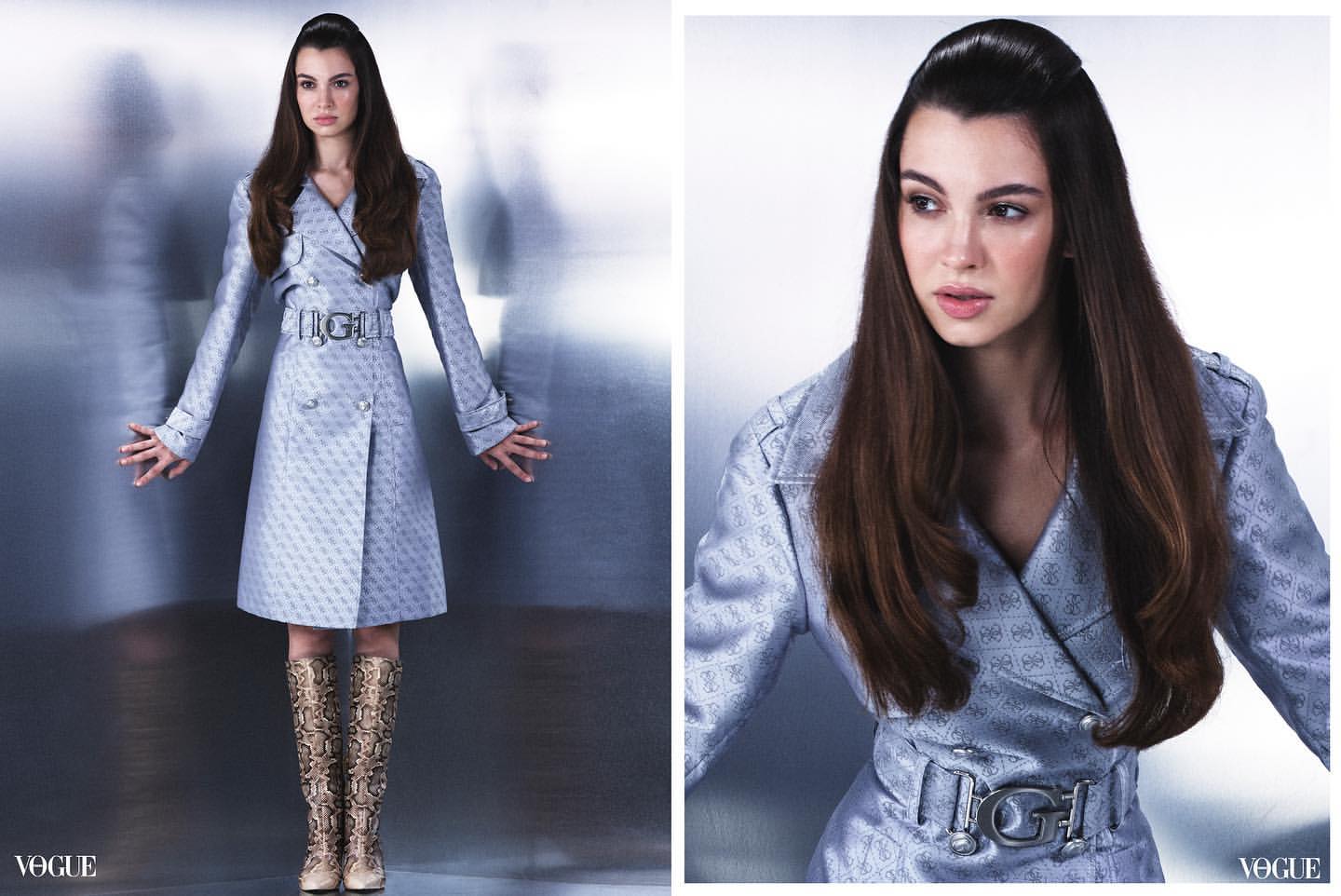 Fashion shot of a woman in a patterned double-breasted trench coat with a wide belt and snake-print boots, posing in a photo studio.