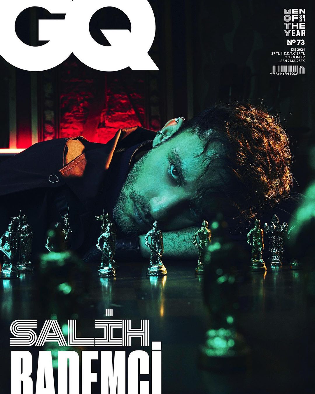 Magazine cover of a man with brown hair laying on a chessboard; the name 'Salih Bademci' is printed at the bottom of the cover.