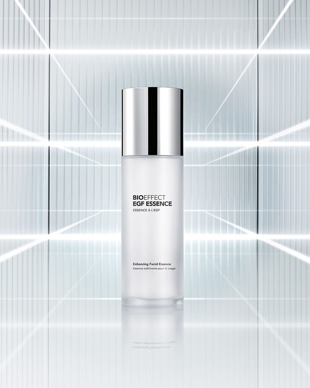 Bioeffect EGF Essence bottle stands out with its minimalist design, featuring a silver cap, set against a geometric backdrop.