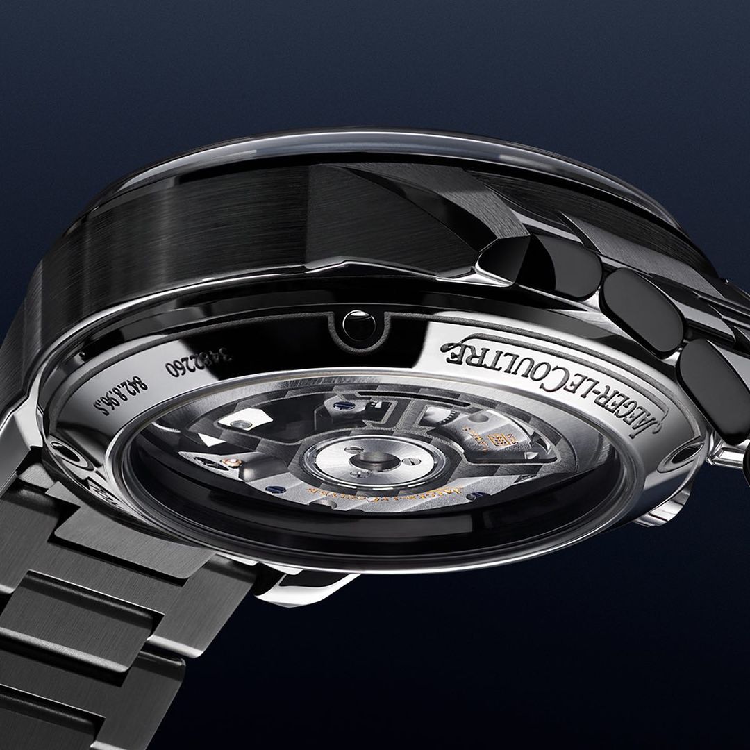 Close-up of a Jaeger-LeCoultre watch with intricate mechanical details visible, showcasing the craftsmanship of the timepiece.