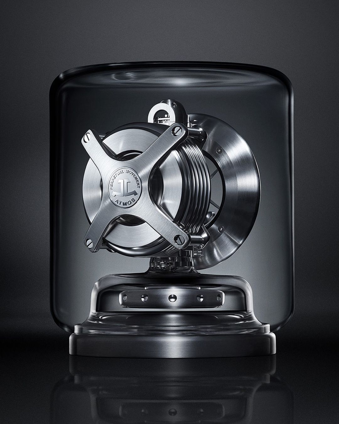 Atmos clock under glass case. The clock features a silver-colored finish with internal components visible under the glass enclosure.